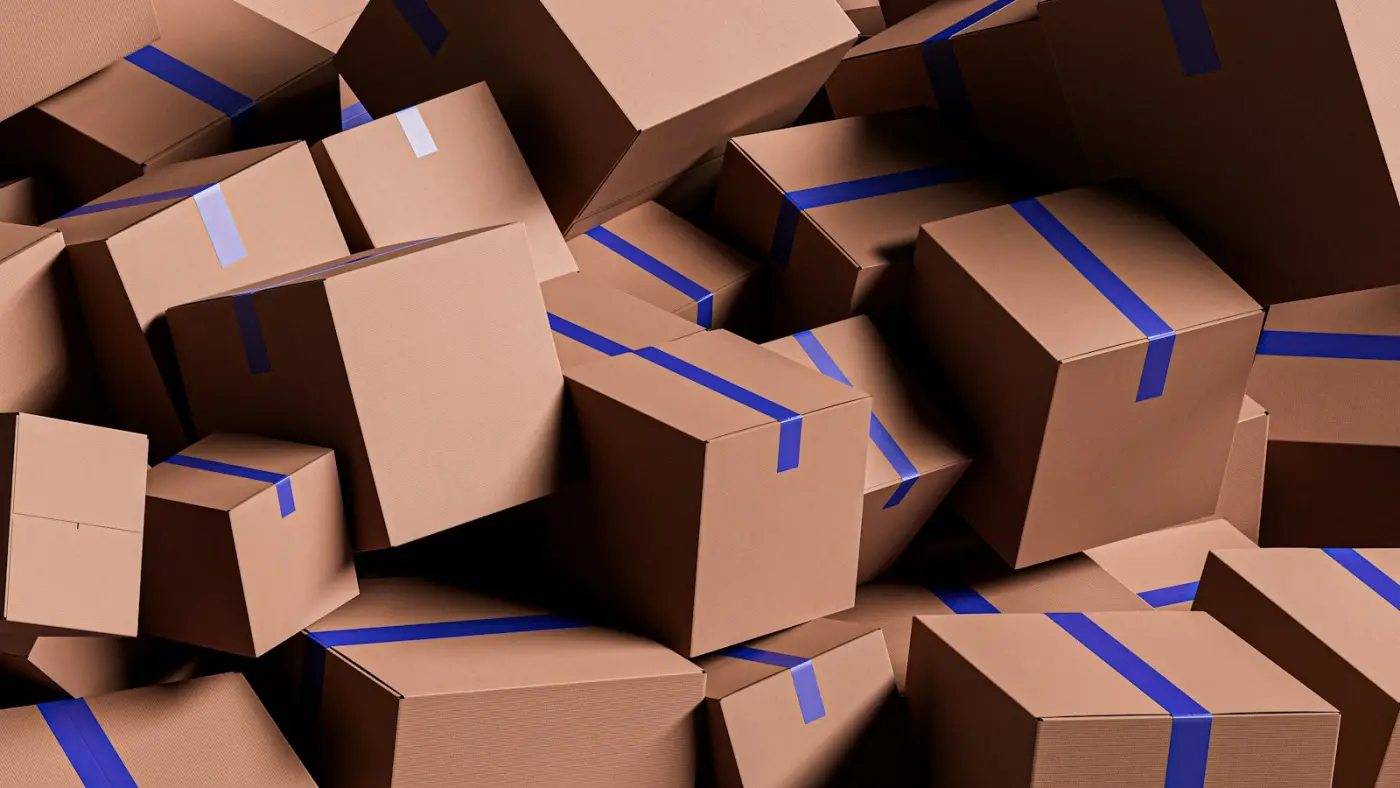 A heap of brown cardboard parcels sealed with blue tape.